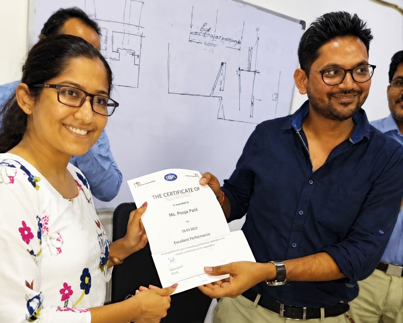 EESPL employee receiving a recognition certificate for exceptional contribution